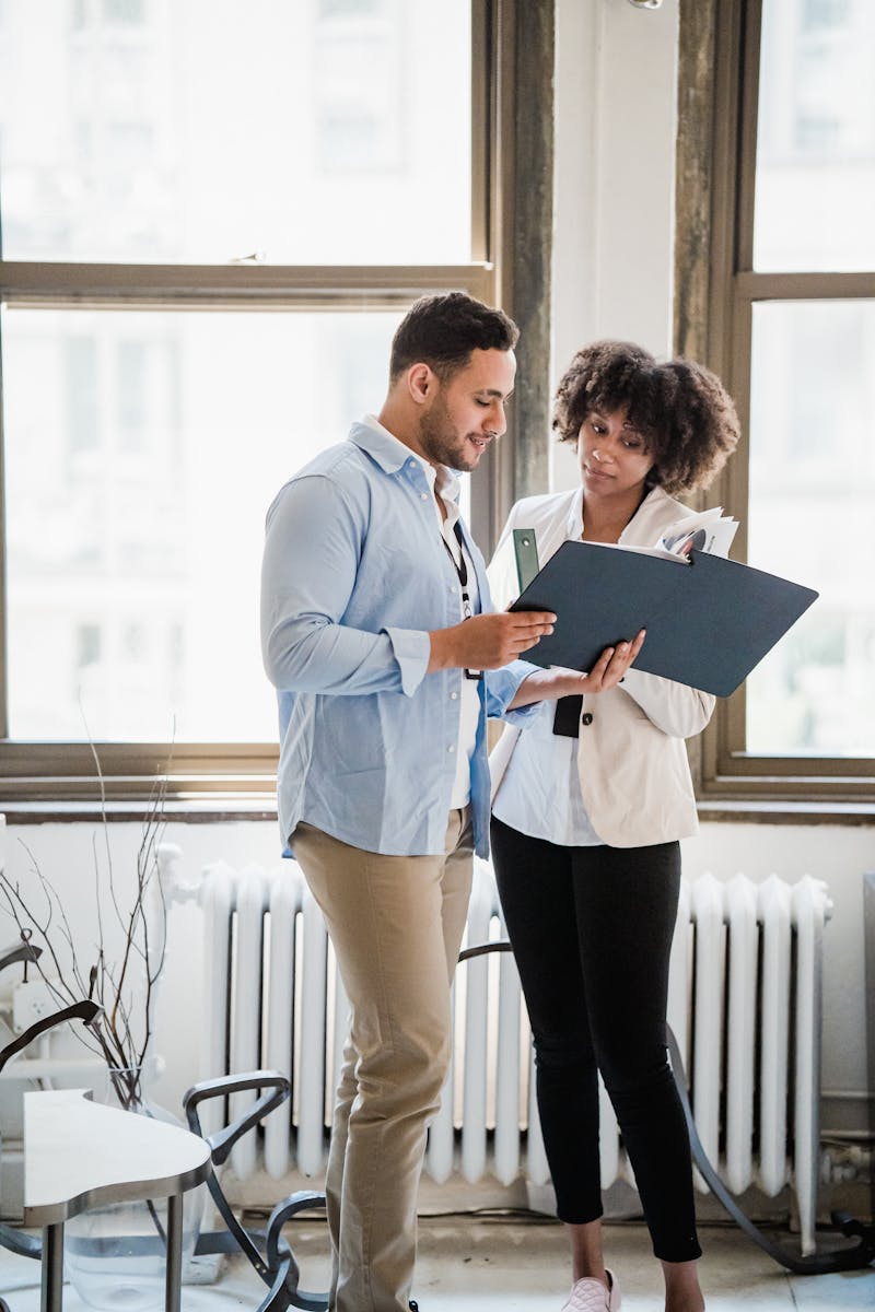 Woman and Man Looking at Documents