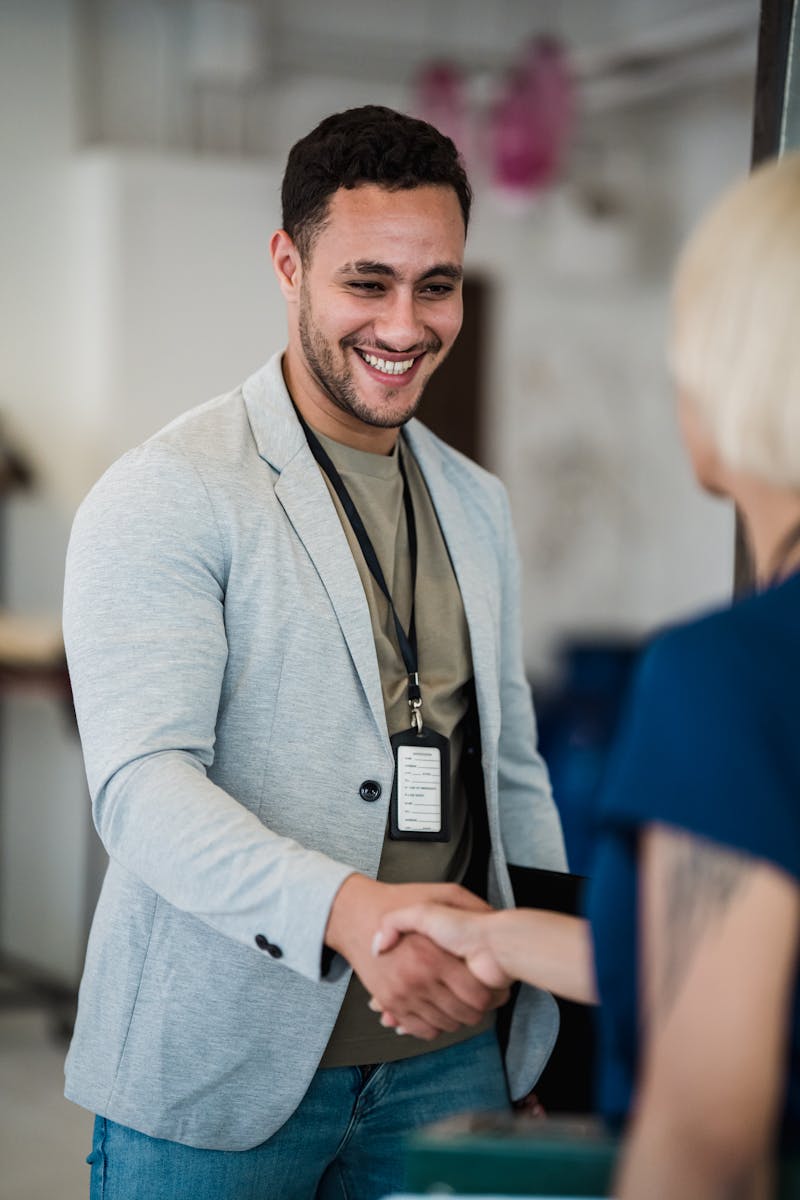 Young Man Shaking Hands with Unrecognizable Woman